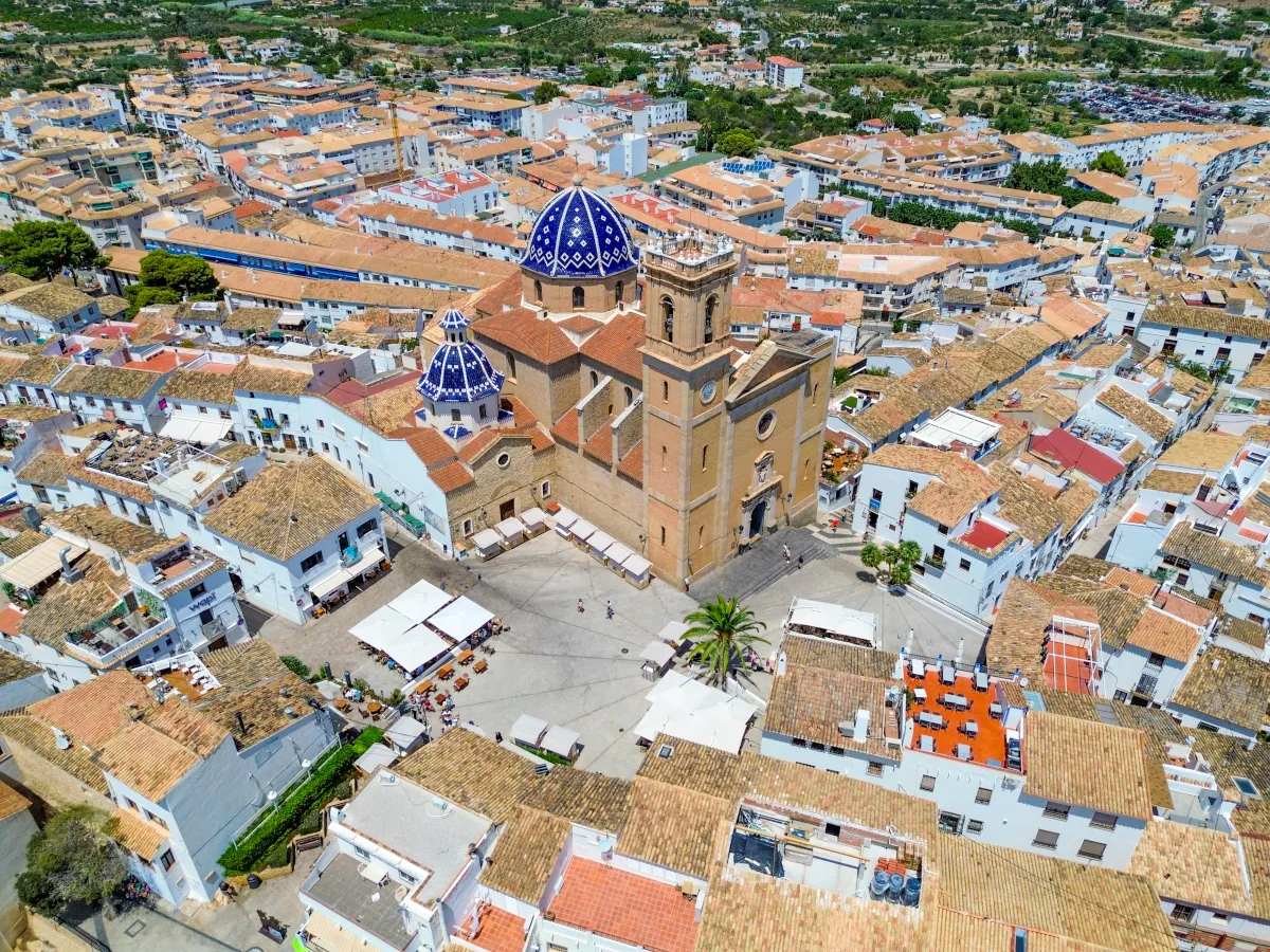 Drone photograph of Altea’s Old Town, showcasing the iconic blue-domed church, whitewashed houses, and surrounding tiled rooftops on the Costa Blanca.