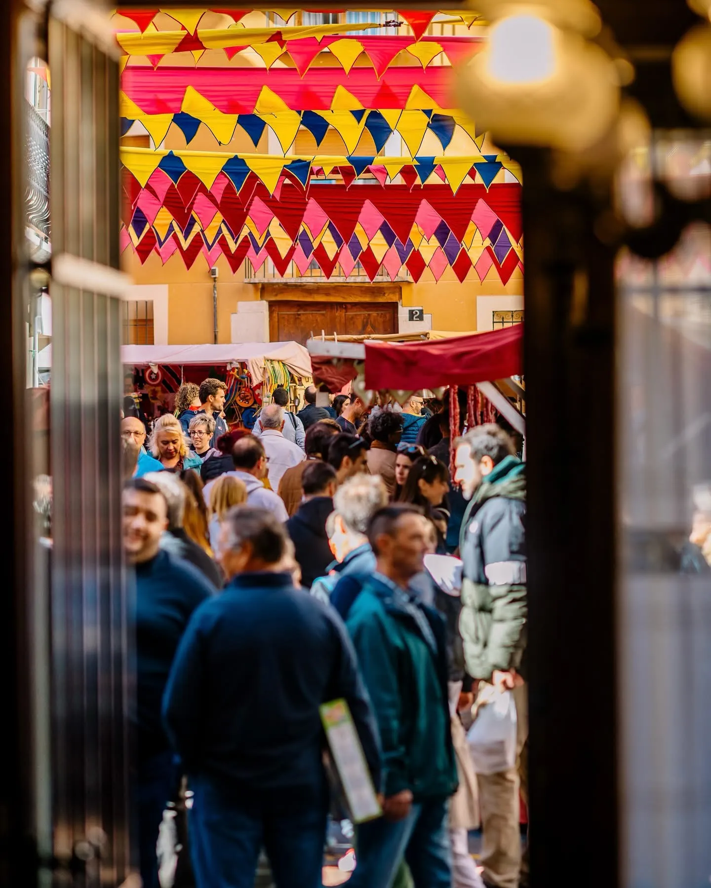 Bustling Streets of the Medieval Market Narrow streets of Cocentaina filled with visitors and colourful medieval decorations during the Fira de Tots Sants.