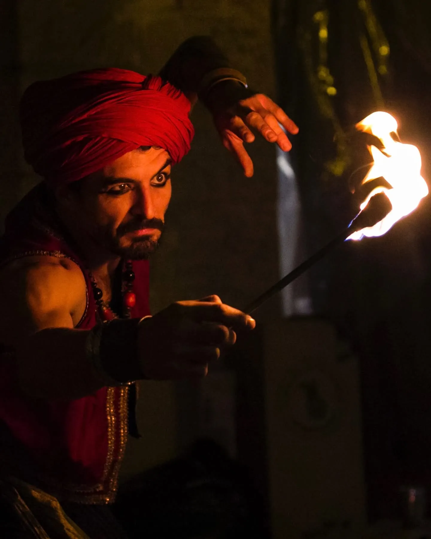 Fire Performer at the Night-Time Arabian Market A fire artist in traditional costume performs at night in the Arabic souk of Cocentaina’s All Saints Fair.